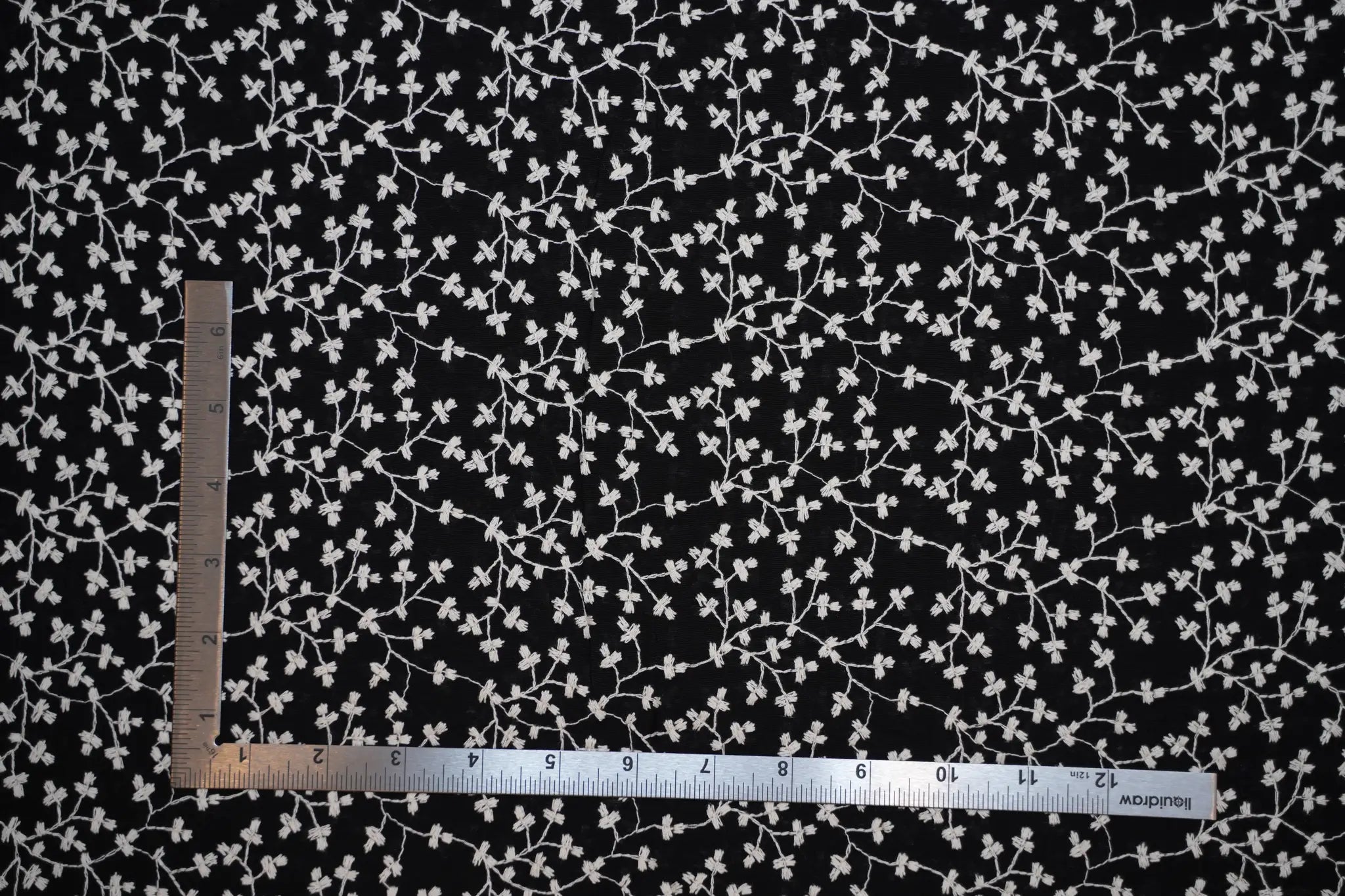 Sheer black cotton with white embroidered vine pattern
